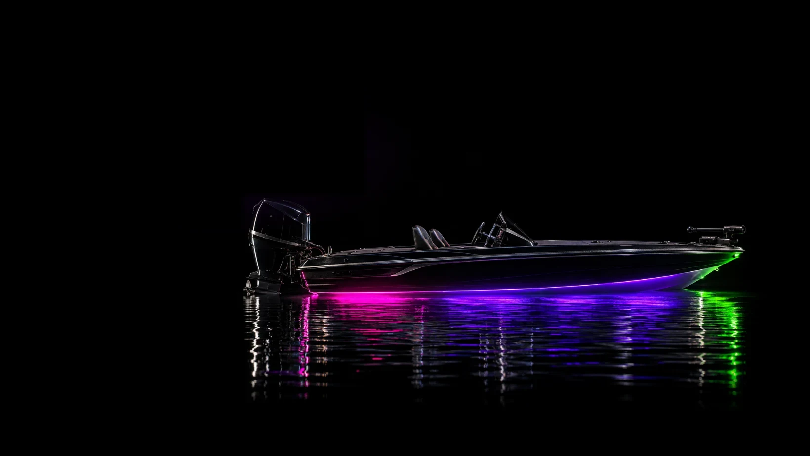 Bass boat glowing with purple and green Elite Glow lighting at night